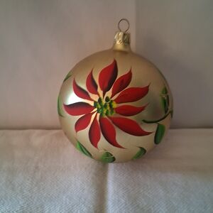 Elegant Gold Ornament with Red and Green Floral Design